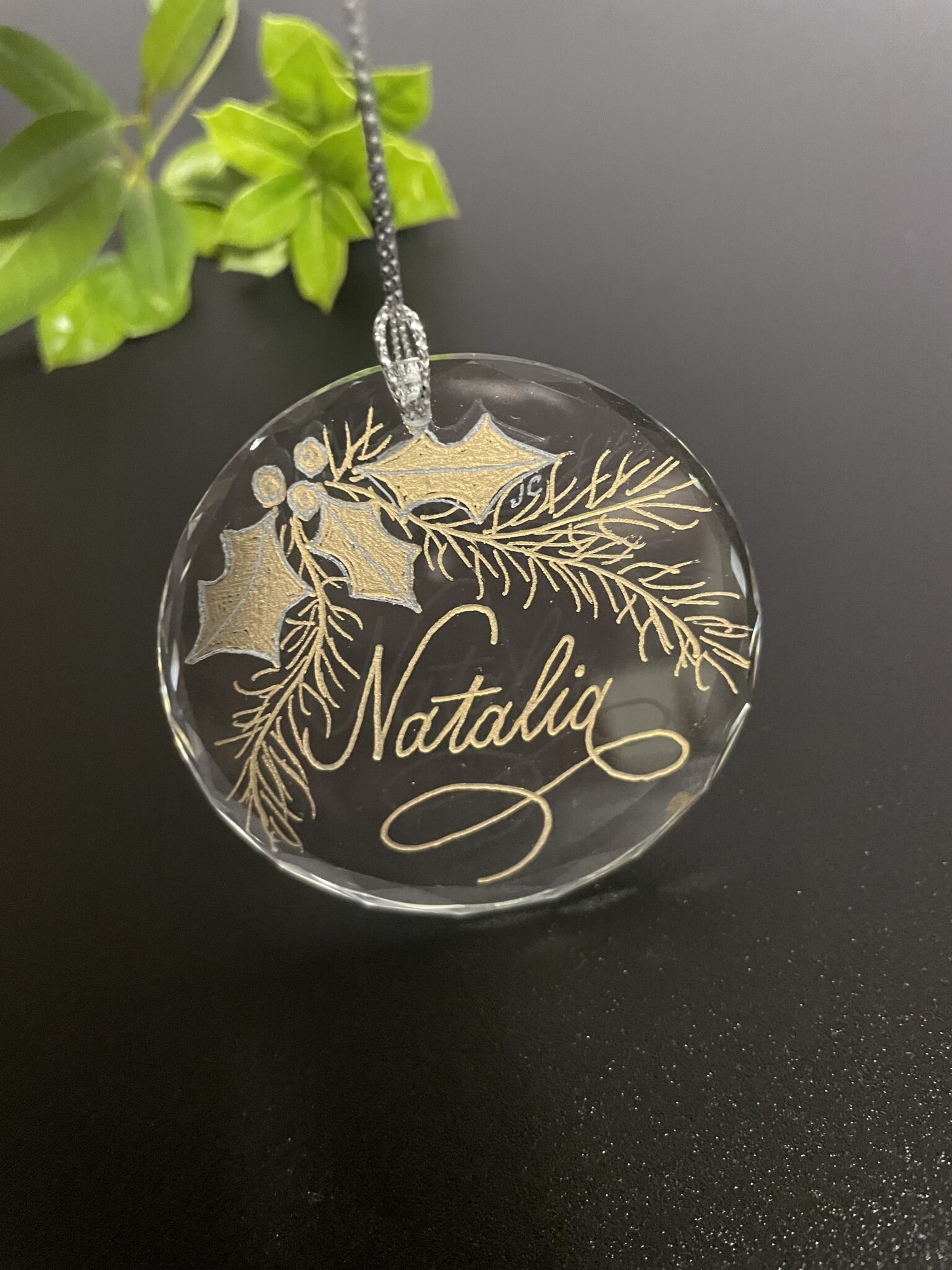 Round, crystal ornament with name "Natalie" hand engraved